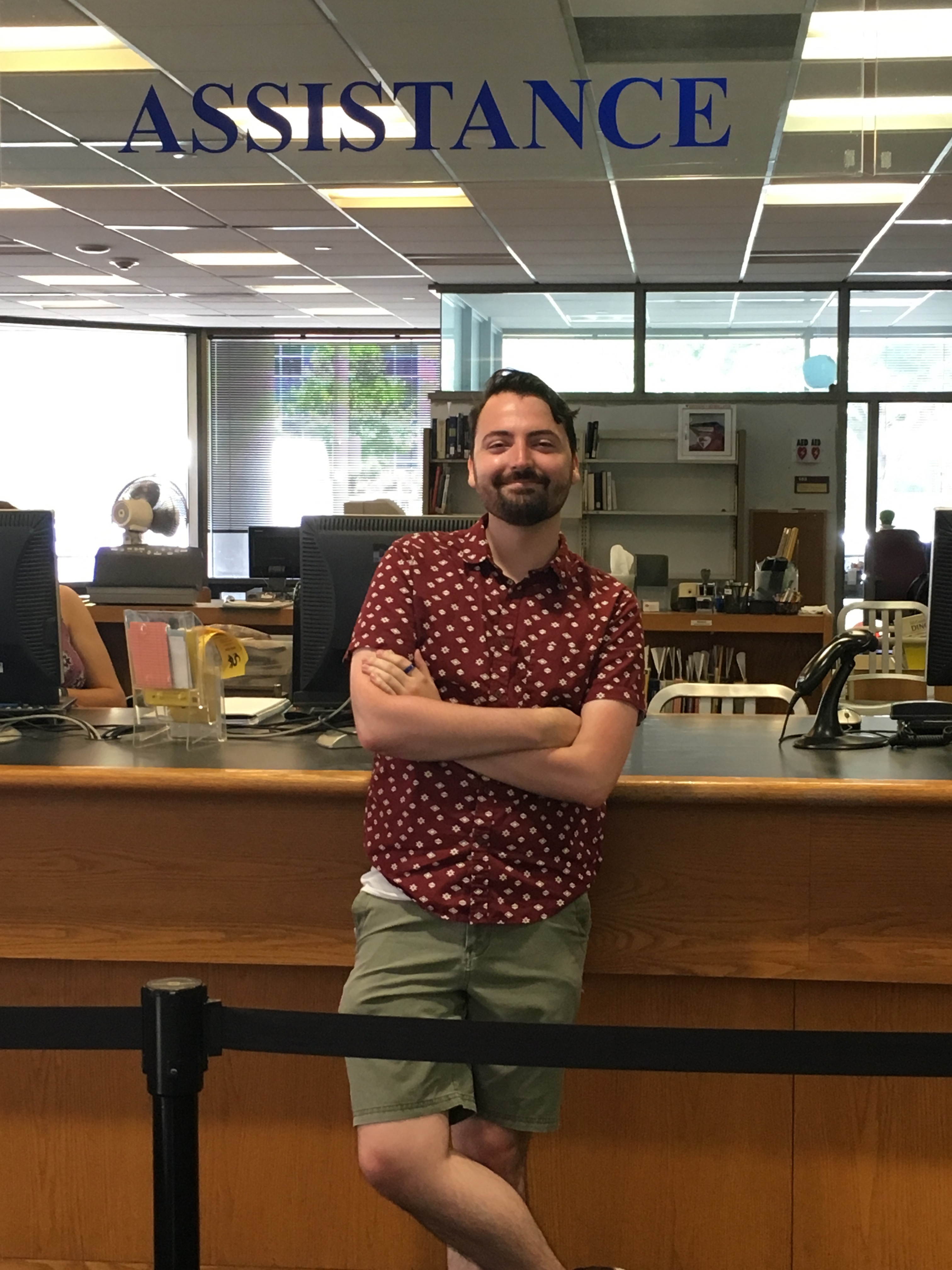 Jesse Webster stands in front of the circulation desk in W. W. Hagerty Library